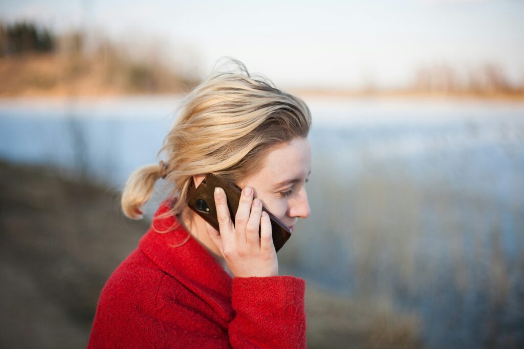 A person on the phone having a free psychotherapy consultation in Canterbury, discussing therapy options.